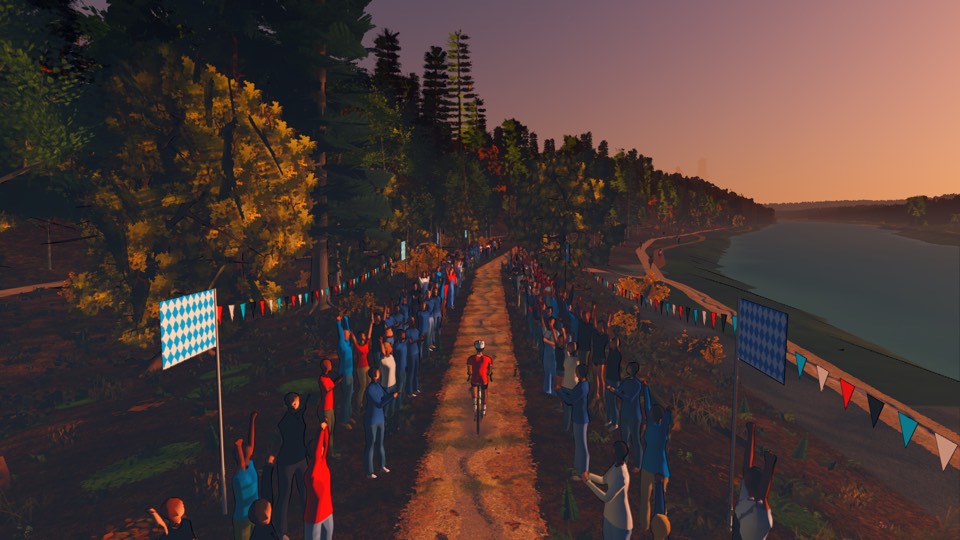 An October evening on the Isar: gold beeches, flags and bunting, and a crowd either side of the path cheering a rider through