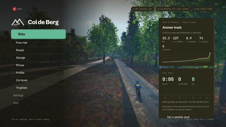 The home screen over a ride being played behind it: Ride, Free ride, Roads, Garage, Phone, Profile, Col book and Trophies, today's road, the Ammer track, and this week's riding